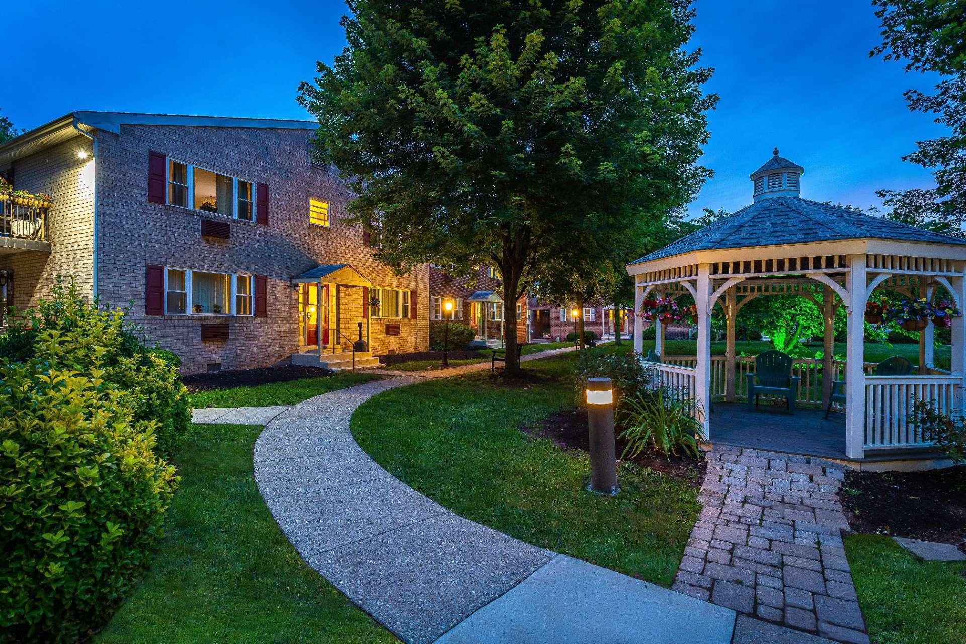 Gazebo and landscaped walkway to residential buildings at Westgate Arms apartments for rent